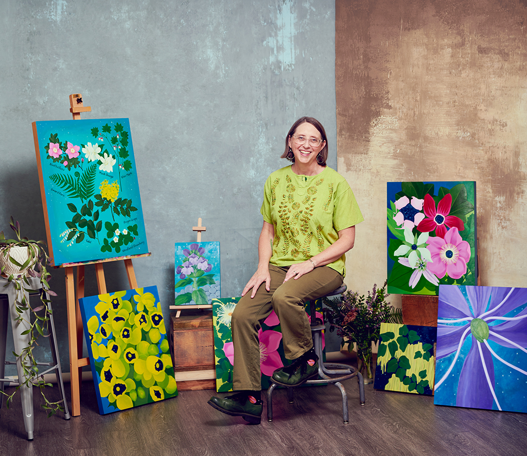 Portland artist Amy Daileda with her botanical paintings